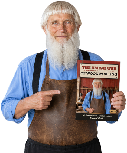 Samuel Beiler holding The Amish Way of Woodworking